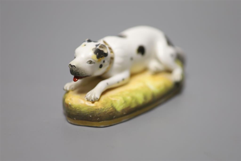 An English porcelain figure of resting dog, c.1830-50, width 13cm